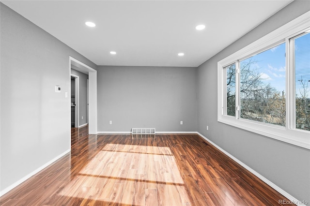 empty room with hardwood / wood-style flooring