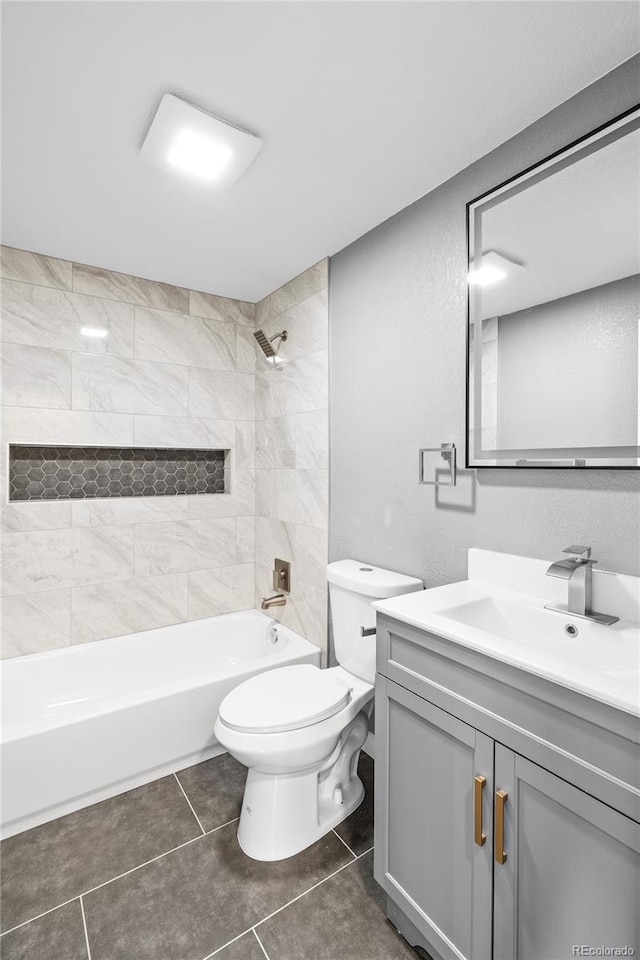 full bathroom with tiled shower / bath combo, vanity, tile patterned flooring, and toilet