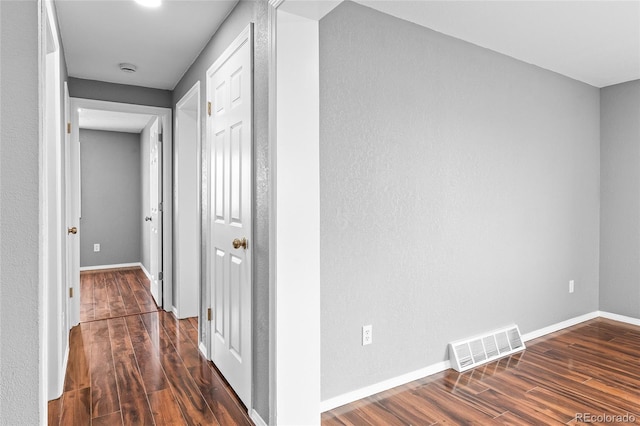 corridor featuring dark wood-type flooring