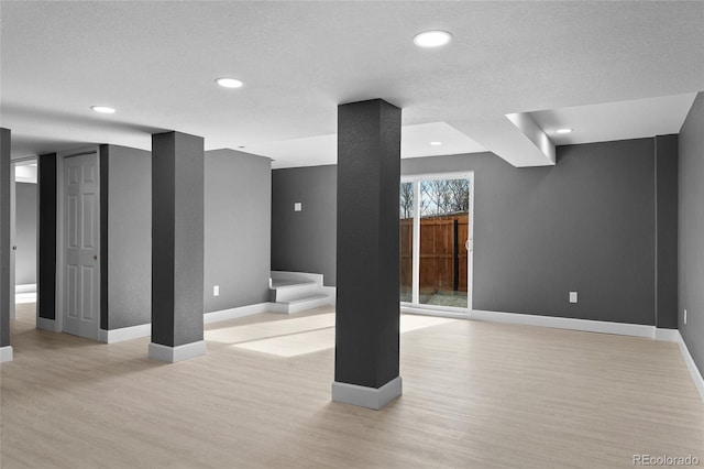 interior space featuring a textured ceiling and light hardwood / wood-style floors