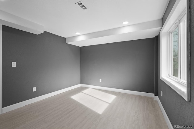 spare room with wood-type flooring