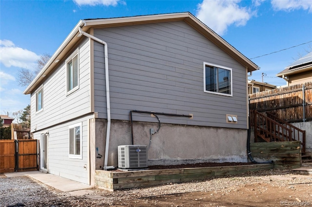 view of side of home featuring central air condition unit