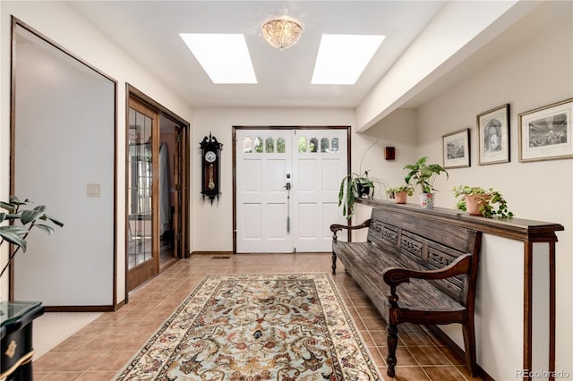 entryway featuring tile patterned floors and a skylight