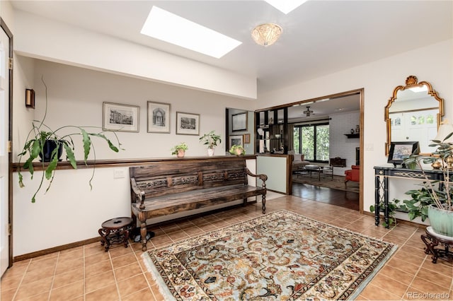 interior space with a skylight and tile patterned floors