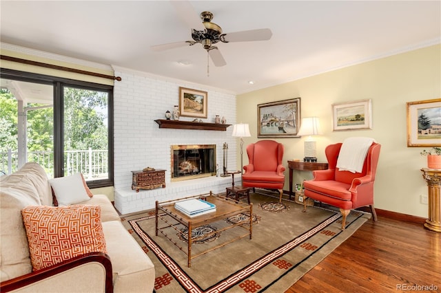 living room with ceiling fan, hardwood / wood-style flooring, a fireplace, and ornamental molding