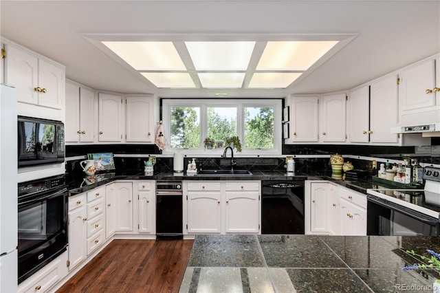 kitchen featuring white cabinetry, dark hardwood / wood-style floors, black appliances, decorative backsplash, and sink