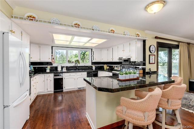 kitchen featuring kitchen peninsula, white fridge, tasteful backsplash, and dark wood-type flooring