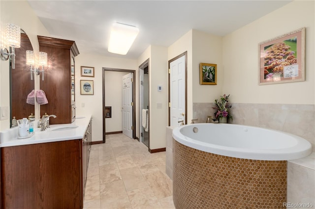 bathroom featuring vanity, tile patterned floors, and a relaxing tiled tub