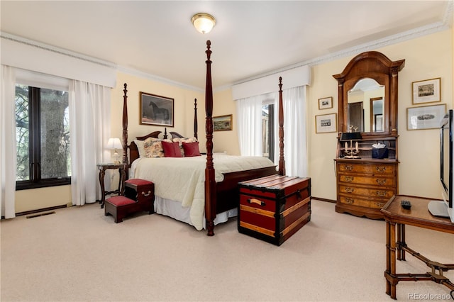 bedroom with carpet floors and crown molding