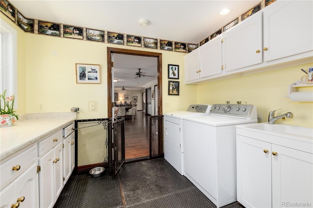 laundry room featuring ceiling fan, dark hardwood / wood-style floors, washing machine and clothes dryer, cabinets, and sink