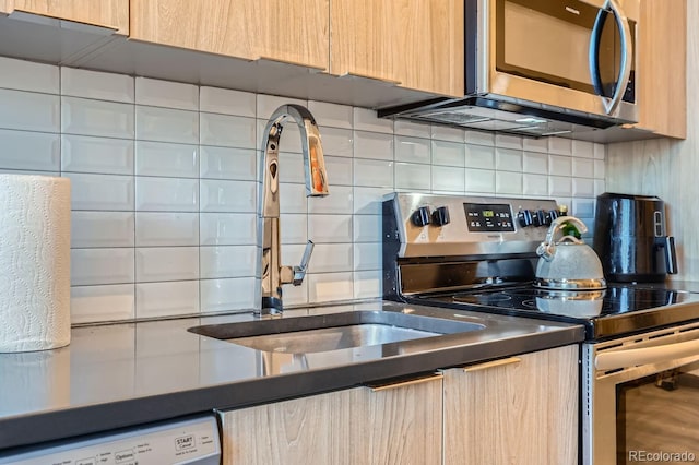 kitchen with decorative backsplash, appliances with stainless steel finishes, and light brown cabinets