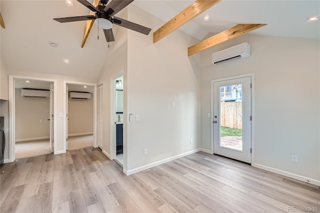 interior space featuring beam ceiling, high vaulted ceiling, a wall mounted air conditioner, and light wood-type flooring