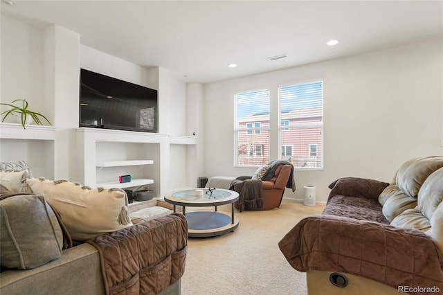 carpeted living area with recessed lighting and visible vents