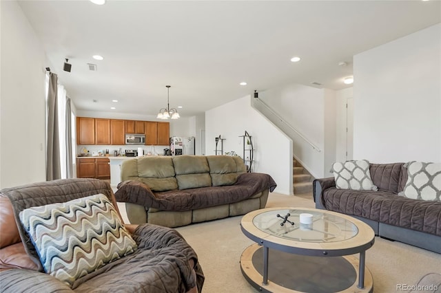 living room featuring stairs, recessed lighting, a notable chandelier, and light colored carpet