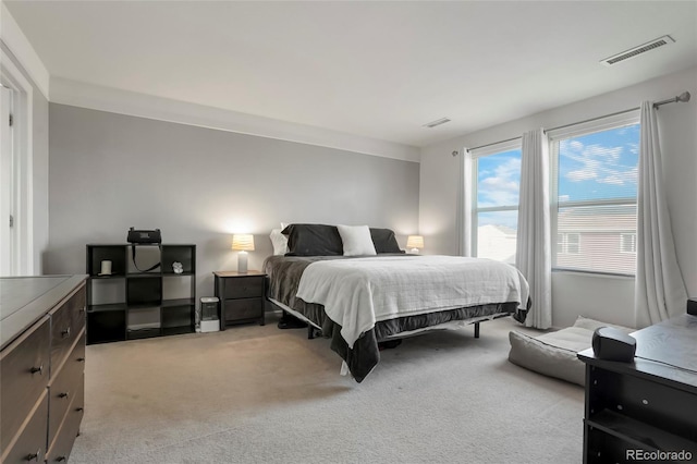 bedroom with light carpet and visible vents