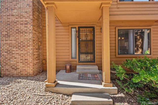 view of exterior entry featuring a porch