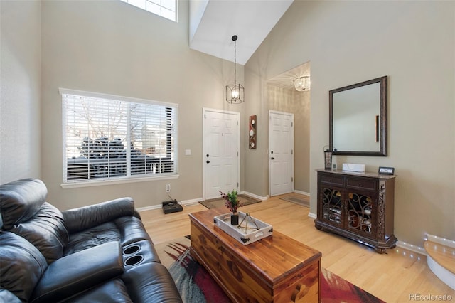 living room with high vaulted ceiling, a wealth of natural light, and hardwood / wood-style flooring