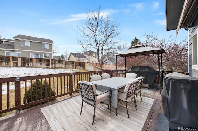 snow covered deck featuring a gazebo and a grill