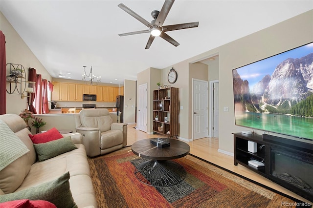 living room featuring ceiling fan and light hardwood / wood-style flooring