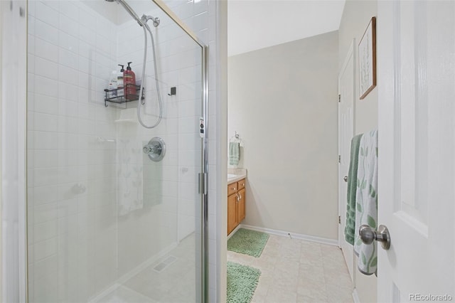 bathroom with a shower with door and vanity