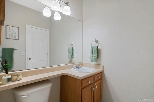 bathroom featuring toilet and vanity