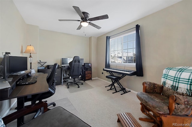 carpeted office space featuring ceiling fan