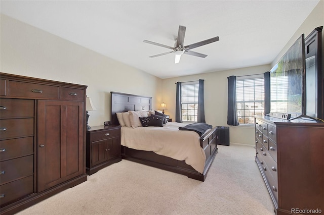 bedroom with ceiling fan and light colored carpet