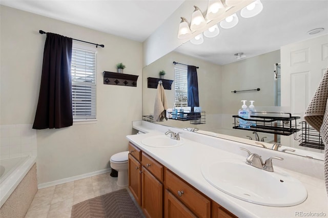 bathroom with tiled bath, vanity, tile patterned floors, and toilet