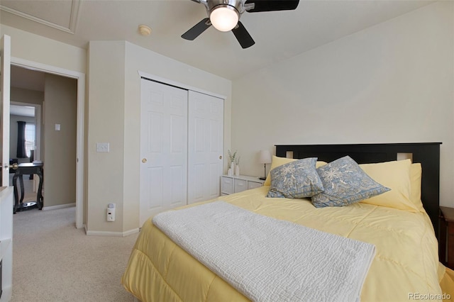 carpeted bedroom with ceiling fan and a closet