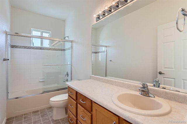 full bathroom featuring enclosed tub / shower combo, vanity, and toilet