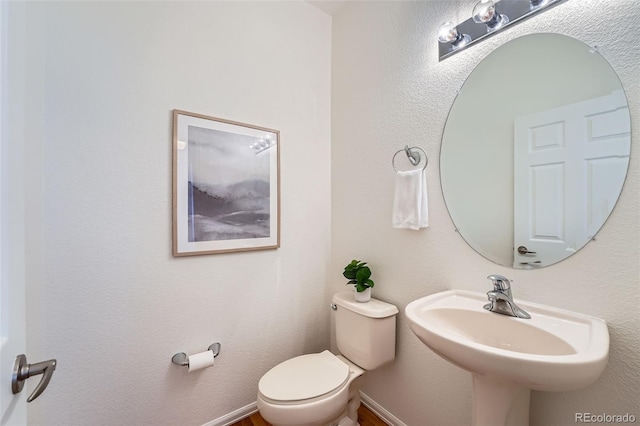 bathroom featuring sink and toilet