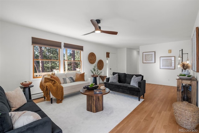 4185 Red Rock Dr, Larkspur, CO 80118 - living area featuring a baseboard heating unit, a ceiling fan, and wood finished floors