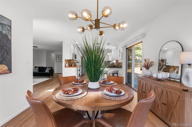 4185 Red Rock Dr, Larkspur, CO 80118 - dining room with light wood-type flooring, a chandelier, and baseboards
