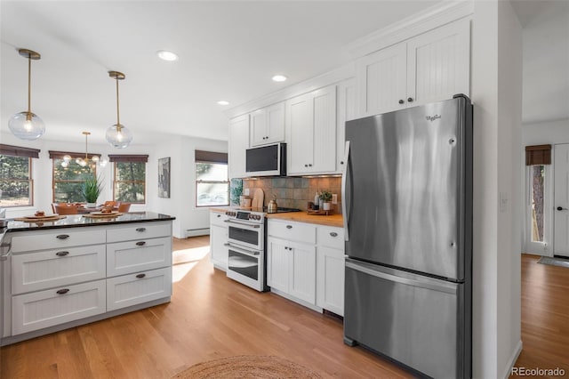 4185 Red Rock Dr, Larkspur, CO 80118 - kitchen featuring stainless steel appliances, white cabinets, light wood finished floors, and recessed lighting