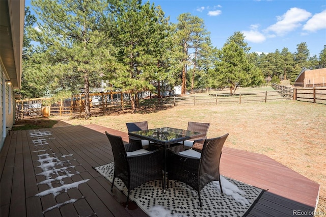 4185 Red Rock Dr, Larkspur, CO 80118 - wooden deck with outdoor dining space and view of wooded area