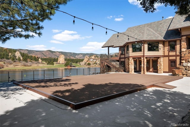 4185 Red Rock Dr, Larkspur, CO 80118 - view of patio / terrace with a water and mountain view and stairway
