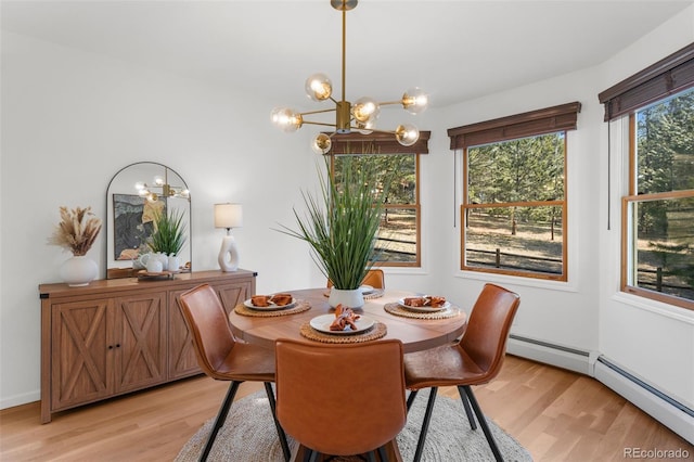 4185 Red Rock Dr, Larkspur, CO 80118 - dining area with a chandelier, light wood-style floors, and baseboard heating