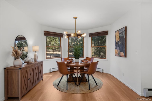 4185 Red Rock Dr, Larkspur, CO 80118 - dining area featuring a baseboard radiator, light wood finished floors, and a chandelier