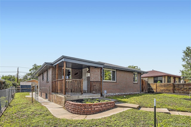 925 Wolff St, Denver, CO 80204 - view of front of house featuring covered porch, brick siding, and a gate