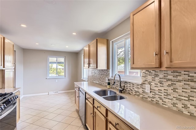 925 Wolff St, Denver, CO 80204 - kitchen with backsplash, light countertops, appliances with stainless steel finishes, recessed lighting, and light tile patterned floors