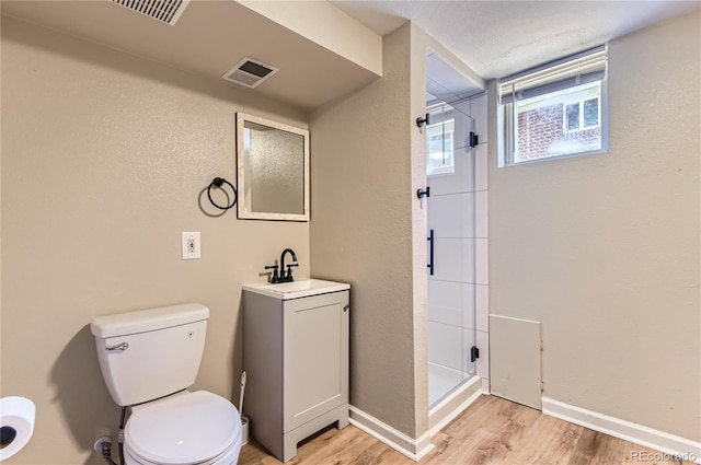 925 Wolff St, Denver, CO 80204 - bathroom with a stall shower, wood finished floors, and vanity