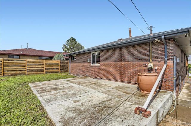 925 Wolff St, Denver, CO 80204 - rear view of property featuring a fenced backyard, brick siding, and a patio