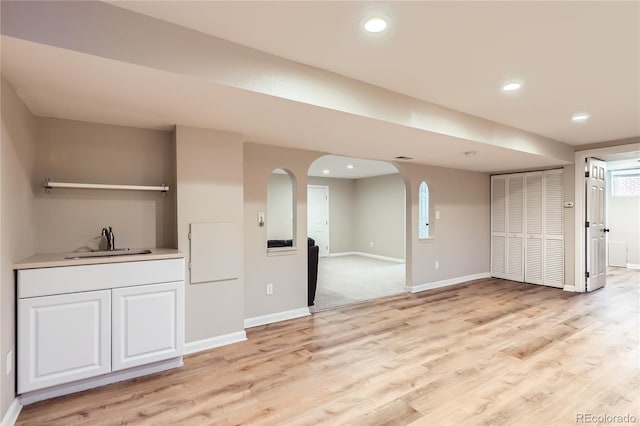 925 Wolff St, Denver, CO 80204 - unfurnished living room with arched walkways, light wood-type flooring, and recessed lighting