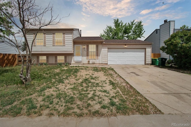 tri-level home with an attached garage and concrete driveway