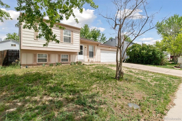 split level home with concrete driveway and a garage