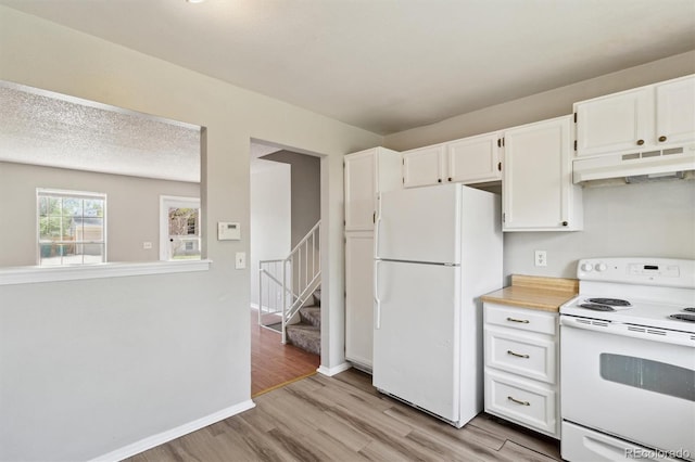 kitchen featuring white appliances, under cabinet range hood, light wood-style floors, light countertops, and white cabinets