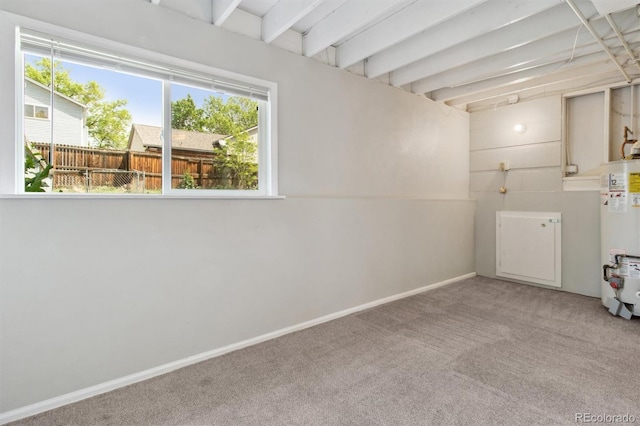 below grade area with gas water heater, carpet, and baseboards