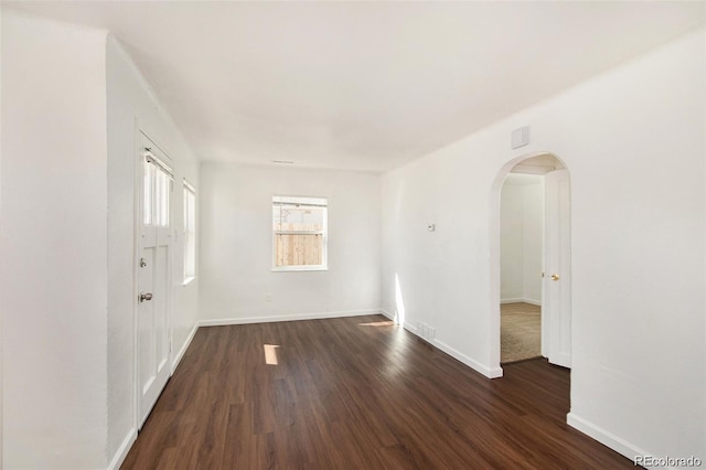 unfurnished room featuring dark hardwood / wood-style flooring