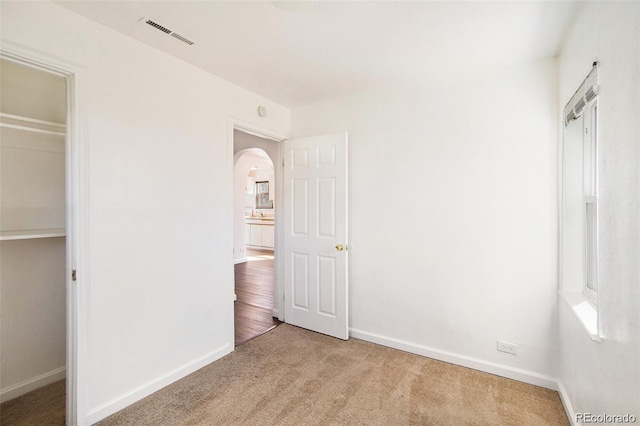 unfurnished bedroom with carpet floors and a closet