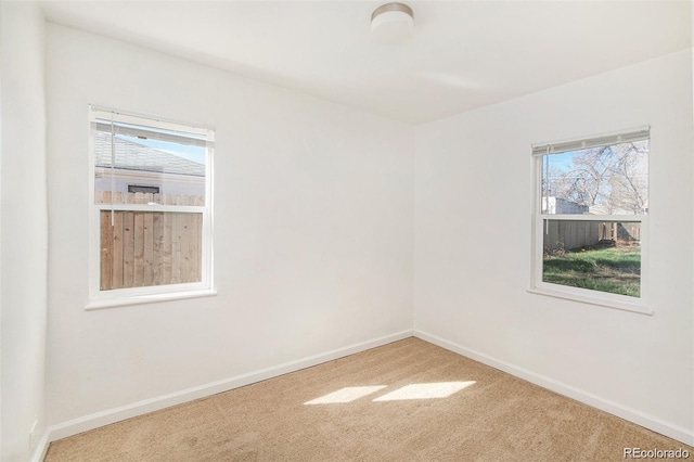 unfurnished room featuring carpet floors and a healthy amount of sunlight